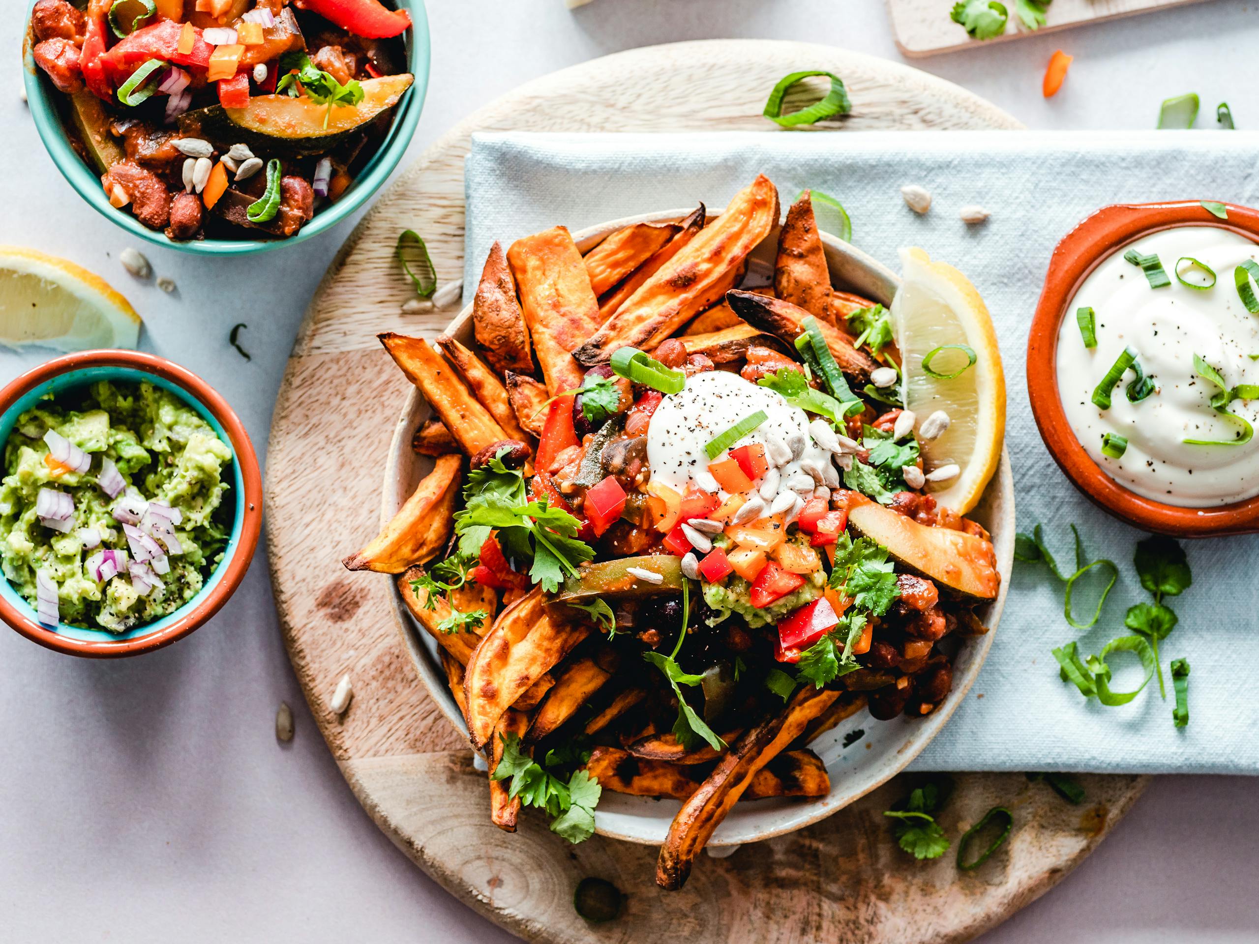 Prototipo tres A vibrant platter of savory sweet potato fries with fresh toppings, perfect for a tasty snack.