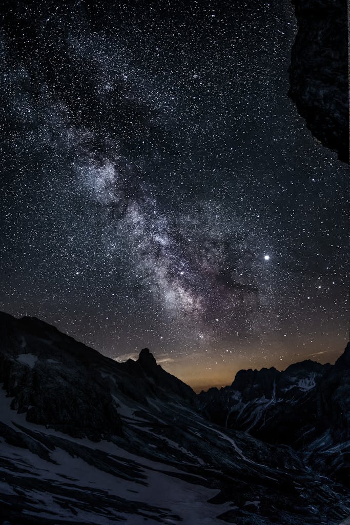 Breathtaking view of the Milky Way galaxy over the mountain peaks in Vigo di Fassa, Italy.