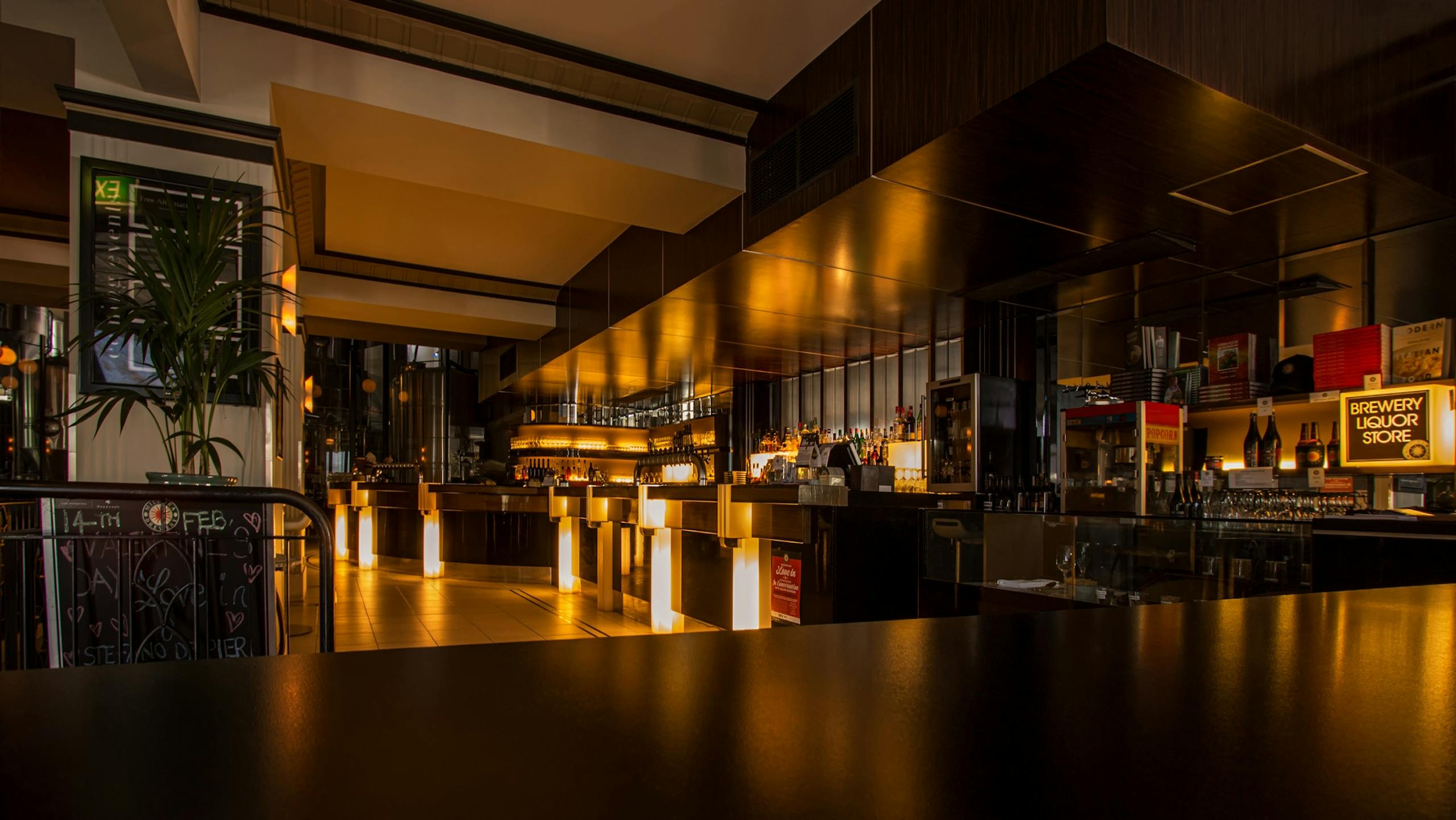 Prototipo tres Stylish modern restaurant interior with warm lighting, elegant design, and luxurious ambiance at night.